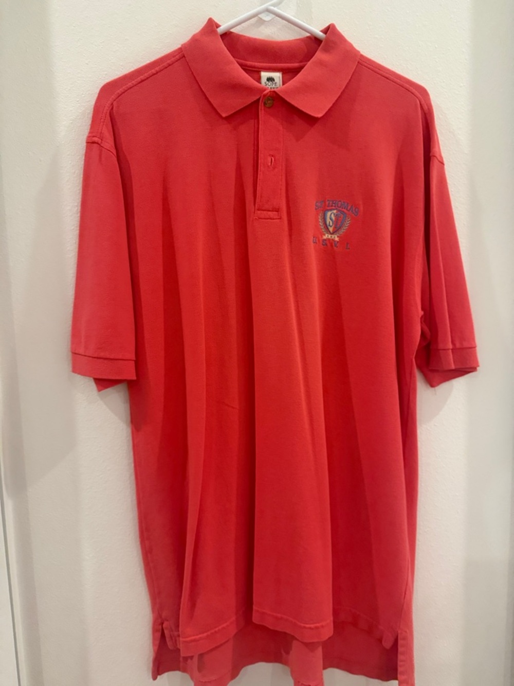 Men’s St Thomas Embroidered Crest Polo in Coral/ orangish color